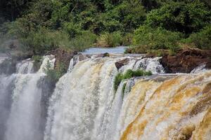 View of the force of the water at the edge of a waterfall at Iguazu Falls, Misiones, Argentina photo