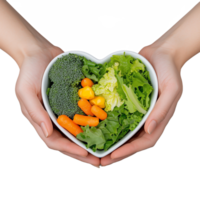 Fresh vegetables in heart-shaped bowl held by hands on transparent background png