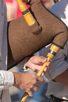 detail of the hands of a bagpipe player playing a traditional bagpipe from Portugal, background concept traditional music photo