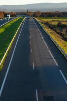view of a lightly trafficked highway at dusk, background for transport concept photo