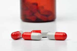 Closeup capsule medicine drug and bottle white background photo