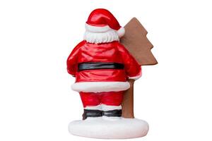Miniature Santa Claus figurine dressed in a classic red suit isolated on a clean white background with a clipping path. Ideal for Christmas, holiday decorations, or festive-themed projects. photo