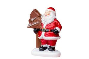 Miniature Santa Claus figurine dressed in a classic red suit isolated on a clean white background with a clipping path. Ideal for Christmas, holiday decorations, or festive-themed projects. photo
