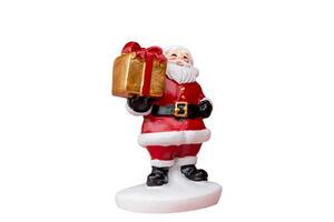 Miniature Santa Claus figurine with gift box dressed in a classic red suit isolated white background with a clipping path photo