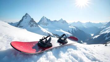 Snowboard resting in the snow with a mountain backdrop photo