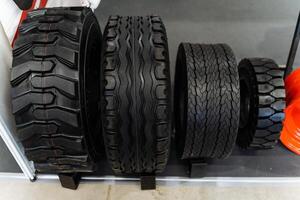 Various tires displayed on shelf for different vehicles photo