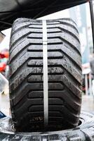 Close up of tire with tread pattern and rubber band, automotive tire photo