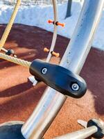 Closeup of a metal bicycle spoke with a screw on it photo