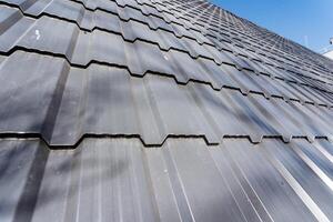 Close up of a metal roof against a clear blue sky backdrop photo