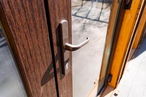 a close up of a door handle on a wooden door photo