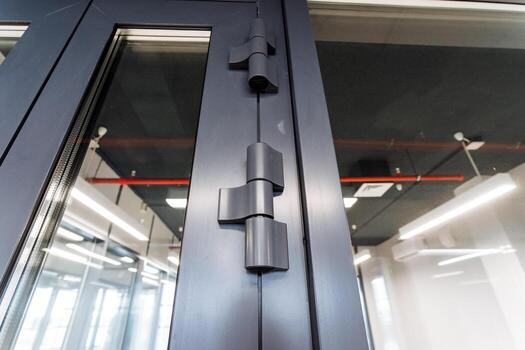 A closeup of a rectangular metal door handle on a building fixture photo