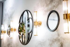 A row of mirrors adorning a wall like spokes in a wheel photo
