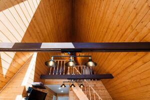 Building made of hardwood with vaulted ceiling, stairs, and wooden flooring photo