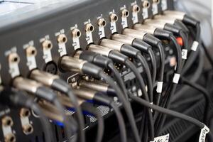 A detailed closeup view of audio equipment featuring numerous cables and various connectors intricately displayed for examination photo