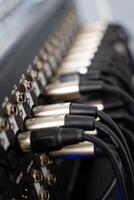 This is a closeup view of audio equipment that emphasizes the important XLR connectors and cables, which are essential for professional sound setups photo