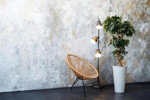 The room contains a wooden chair and a lamp on the floor photo