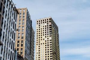 Skyscrapers rise high against a clear blue sky in urban design photo