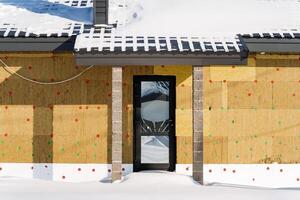 A house with a door and windows covered in snow photo