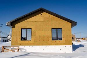 A house with a roof made of wood and a wall made of wood photo