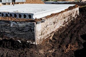 Construction Site Foundation A sturdy concrete base paired with surrounding soil to support the structure effectively and sustainably photo