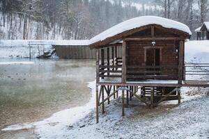 A small wooden cabin sitting on a small wooden platform photo
