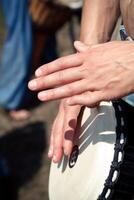 a close up of a person s hands playing a drum photo