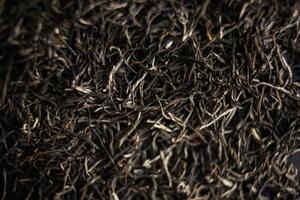 Closeup of black tea leaves, resembling a pattern of tiny tree twigs photo
