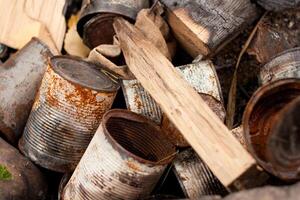 A collection of old metal cans and a piece of natural wood photo