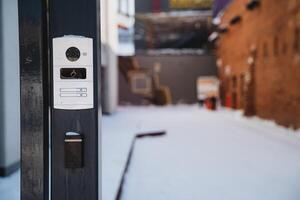 Modern door intercom system with camera for calls and access control in building or office photo
