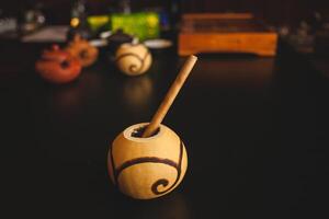 a ball with a straw in it on a table photo