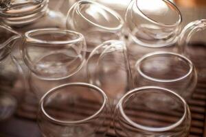 a bunch of empty wine glasses are stacked on top of each other on a table photo