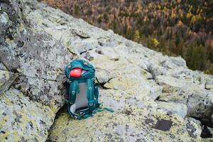 Top view of a hiking backpack with hiking equipment, a sports backpack, a first aid kit on a trip, a set for racking in the forest. photo