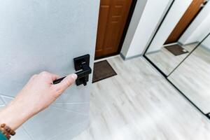 Hand holding door handle open door, front door to house, hallway, photo