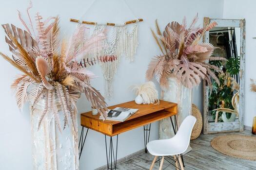 A room with a desk, chair and a table with some plants photo