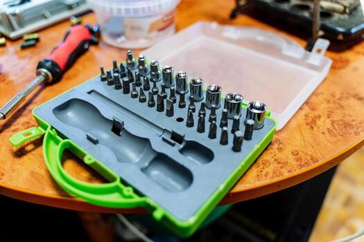A set of tools. Box with various nozzles for screwdriver. Keys for repair. photo