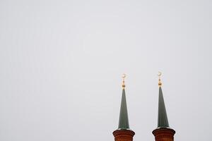 Two tall buildings with gold spires photo