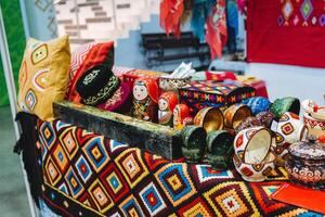 Objects of folk art. Exhibition of Handicrafts. Patterns on fabric gifts. photo