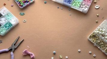 Crafting with colorful beads on a flat workspace with tools and containers in bright daylight video