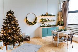 Interior picture. A wreath of spruce branches, a festive dinner on the table. Preparations for the holiday. New Year and Christmas photo