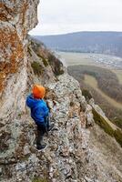 Uklykaya Rock Mountain Range, Bashkortostan, Russia. Nature of the Southern Urals. Gray stone ridge against the background of autumn forest. Landscape. photo