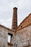 Old brick building factory. Ancient architecture. Brick pipe. A monument of cultural heritage. Remains of the wall photo
