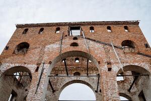 Medieval building. The windows of the arch are made of red brick. Old building photo