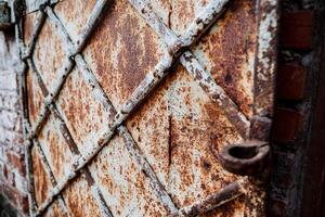 pattern rusty rhombus. old door surface. worn metal background photo