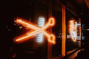 Neon sign in the form of scissors and combs. Bright and colorful photography. photo