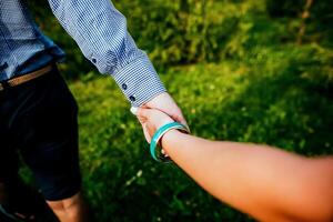 Close-up of a woman and a man holding out their hands, two people holding hands. The symbol is a sign of sincere feelings, a loved one. the concept of true friendship, outdoors photo