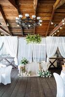 flowers and candles in the decoration of the wedding table, wedding decor, tablecloth made of natural materials, table setting. photo