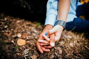 Close-up of a woman and a man holding out their hands, two people holding hands. The symbol is a sign of sincere feelings, a loved one. the concept of true friendship, outdoors photo
