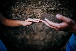 Close-up of a woman and a man holding out their hands, two people holding hands. The symbol is a sign of sincere feelings, a loved one. the concept of true friendship, outdoors photo