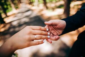 Close-up of a woman and a man holding out their hands, two people holding hands. The symbol is a sign of sincere feelings, a loved one. the concept of true friendship, outdoors photo