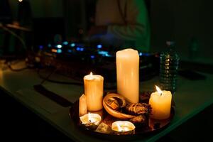 A table with candles and a dj photo
